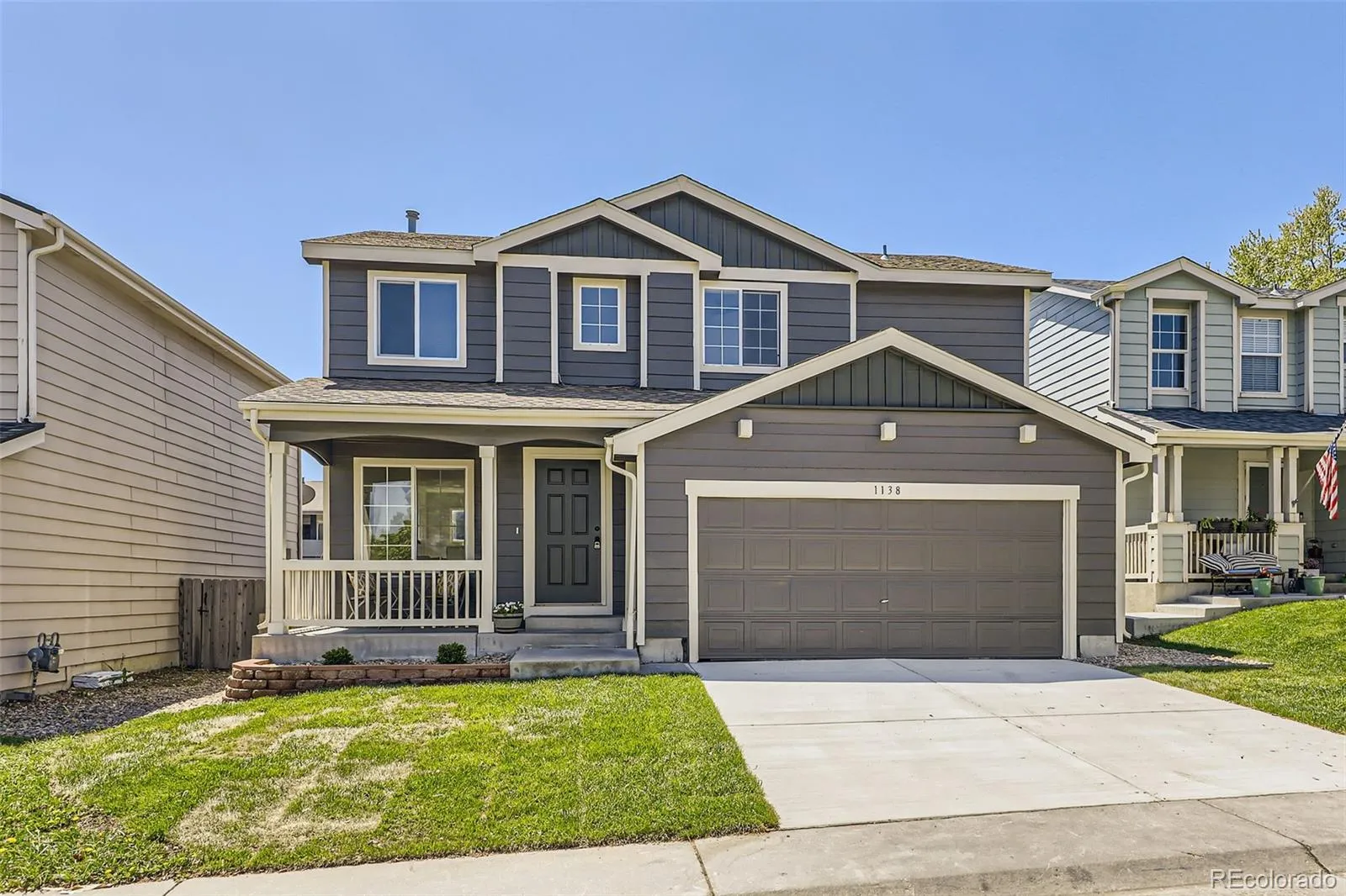 Two-story grey home with covered front porch and two-car garage, 1138 West 84th Place, Denver