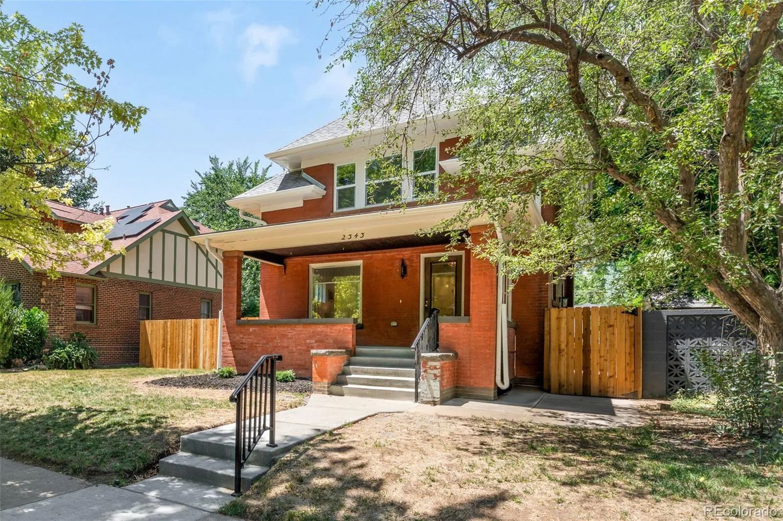Exterior of 2343 Dahlia Street, Denver, with yard and wooden fence